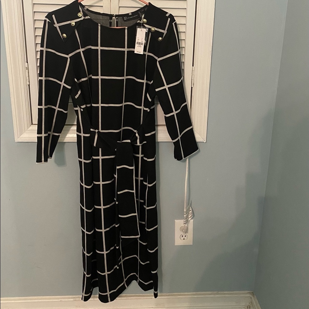 Beautiful black dress with white lines.New with Tag. Never worn.